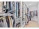 Large walk-in closet featuring metal baskets and shelving to keep you well organized at 11571 Little River Way, Parrish, FL 34219