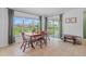 Bright dining area with large window and sliding glass doors leading to the back yard at 11571 Little River Way, Parrish, FL 34219