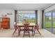 Light-filled dining area with tile floors, view of backyard, and access to the patio at 11571 Little River Way, Parrish, FL 34219