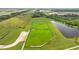 Aerial view of the fenced dog park complete with a running area, benches, and shade trees in a pet-friendly community at 11571 Little River Way, Parrish, FL 34219
