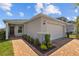 Beautiful home with a brick driveway and a well-maintained front lawn at 11571 Little River Way, Parrish, FL 34219