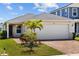 Charming single-Gathering home with a brick driveway and palm tree at 11571 Little River Way, Parrish, FL 34219