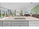 Open kitchen boasts quartz counters, stainless dishwasher, and a view into the living room at 11571 Little River Way, Parrish, FL 34219