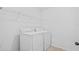 Efficient laundry room with appliances and shelving offering practical space for household chores and organization at 11571 Little River Way, Parrish, FL 34219