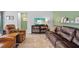 Inviting living room featuring a plush sofa, media console, and soft area rug at 11571 Little River Way, Parrish, FL 34219