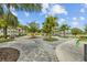 Chic outdoor lounge area features an outdoor seating area and gazebo overlooking the neighborhood pond at 11571 Little River Way, Parrish, FL 34219