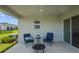 Cozy patio area with comfortable seating, a fire pit, and views of the backyard, perfect for outdoor relaxation at 11571 Little River Way, Parrish, FL 34219
