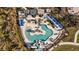 Aerial shot of the community pool with splash pad, palm trees, and covered seating at 11571 Little River Way, Parrish, FL 34219