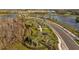 Aerial view of a community pump track with lush green landscaping and surrounding nature at 11571 Little River Way, Parrish, FL 34219