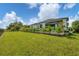 Spacious backyard featuring a well-manicured lawn and elegant landscaping, ideal for outdoor activities and entertaining at 14322 Cando Ave, Port Charlotte, FL 33981
