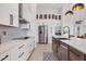 Modern kitchen features stainless steel appliances, a large island, custom cabinetry and stylish backsplash at 14322 Cando Ave, Port Charlotte, FL 33981