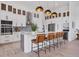Open kitchen featuring an island with seating, stainless steel appliances, modern cabinetry, and designer backsplash at 14322 Cando Ave, Port Charlotte, FL 33981