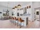 Bright, spacious kitchen boasts modern fixtures, a large island with seating, and stylish pendant lighting at 14322 Cando Ave, Port Charlotte, FL 33981