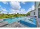 Gorgeous pool and spa combo with beautiful views in a lush backyard setting, perfect for outdoor relaxation at 14322 Cando Ave, Port Charlotte, FL 33981