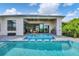 Outdoor pool and spa with covered living area, offering a serene and private oasis for relaxation and entertainment at 14322 Cando Ave, Port Charlotte, FL 33981