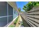 A landscaped backyard features a stepping stone path and a screen enclosed porch at 148 N Blvd Of The Presidents, Sarasota, FL 34236