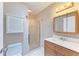 Bathroom featuring a vanity with a wood-stained cabinet and a glass-enclosed shower at 148 N Blvd Of The Presidents, Sarasota, FL 34236
