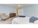 Bright bedroom featuring pale blue walls, wood-look flooring, and a closet at 148 N Blvd Of The Presidents, Sarasota, FL 34236