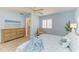 Bright bedroom featuring pale blue walls, wood-look flooring, and a comfortable seating area at 148 N Blvd Of The Presidents, Sarasota, FL 34236