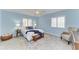 Calm bedroom featuring two windows, wood-look flooring, and a seating area at 148 N Blvd Of The Presidents, Sarasota, FL 34236