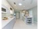 Well-lit kitchen showcasing white cabinets, quartz countertops, and stainless steel appliances at 148 N Blvd Of The Presidents, Sarasota, FL 34236
