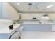 Bright eat-in kitchen features white cabinetry, stone countertops, and a work area at 148 N Blvd Of The Presidents, Sarasota, FL 34236