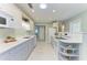 Spacious kitchen with white cabinets, quartz countertops, and stainless steel appliances at 148 N Blvd Of The Presidents, Sarasota, FL 34236