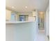 Kitchen with white cabinets and marble countertops at 148 N Blvd Of The Presidents, Sarasota, FL 34236