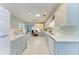 Large kitchen with stone countertops, white cabinets, and stainless appliances at 148 N Blvd Of The Presidents, Sarasota, FL 34236