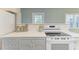 Bright kitchen with white cabinets, quartz countertops, and stainless steel appliances at 148 N Blvd Of The Presidents, Sarasota, FL 34236