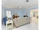 A comfortable living room features neutral tones, ceiling fan and white floors at 148 N Blvd Of The Presidents, Sarasota, FL 34236