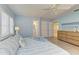 Well-lit main bedroom features wood-look tile, plantation shutters, and ensuite bathroom at 148 N Blvd Of The Presidents, Sarasota, FL 34236