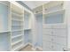 Large walk-in closet with custom shelving and built-in drawers at 148 N Blvd Of The Presidents, Sarasota, FL 34236