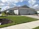 Charming single-story home featuring a well-manicured lawn and an attached two-car garage at 16152 Isola Pl, Bradenton, FL 34211