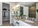 Elegant bathroom featuring dual sinks, generous counter space, and a separate room with a walk-in closet at 16210 Isola Pl, Bradenton, FL 34211