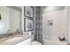 Relaxing bathroom featuring a shower-tub combo, patterned shower curtain and decorative floral art at 16210 Isola Pl, Bradenton, FL 34211