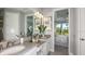 Luxurious bathroom with double sinks, elegant fixtures, and a view into the serene Primary bedroom at 16210 Isola Pl, Bradenton, FL 34211