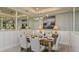 Elegant dining room featuring modern lighting, large mirrors, and a beautifully set table at 16210 Isola Pl, Bradenton, FL 34211