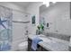 Clean bathroom featuring granite counters, decorative shower curtain, and tile floors at 17616 Bright Wheat Dr, Lithia, FL 33547