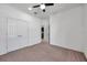 Spacious bedroom with plush carpeting, ceiling fan and a double-door closet, providing comfort and ample storage at 17616 Bright Wheat Dr, Lithia, FL 33547
