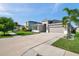 Well maintained exterior with a landscaped front yard, long driveway, and attached two-car garage at 17616 Bright Wheat Dr, Lithia, FL 33547