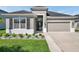 Charming single-story home featuring a well-manicured lawn and attached two-car garage at 17616 Bright Wheat Dr, Lithia, FL 33547