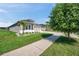 Suburban house featuring a manicured lawn, side driveway, and an attached two-car garage at 17616 Bright Wheat Dr, Lithia, FL 33547