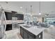 Spacious kitchen featuring dark cabinets, a large island with seating, and modern appliances at 17616 Bright Wheat Dr, Lithia, FL 33547