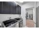 Well-equipped laundry room features a modern washer and dryer with storage cabinets and access to the walk-in closet at 17616 Bright Wheat Dr, Lithia, FL 33547