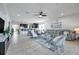 Bright living room features neutral decor, tile floors, an open floor plan, and a unique hanging chair at 17616 Bright Wheat Dr, Lithia, FL 33547