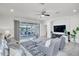 Bright living room with stylish seating, modern ceiling fan, and access to a screened in lanai at 17616 Bright Wheat Dr, Lithia, FL 33547
