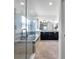 A luxurious main bathroom featuring a glass-enclosed shower and soaking tub with double vanity sinks at 17616 Bright Wheat Dr, Lithia, FL 33547