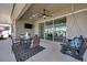 Covered patio with ceiling fan, outdoor furniture, and peaceful lake view at 17616 Bright Wheat Dr, Lithia, FL 33547
