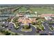 Aerial view of clubhouse with pool, tennis courts, parking lot, and manicured landscaping at 17810 Gawthrop Dr # 406, Bradenton, FL 34211